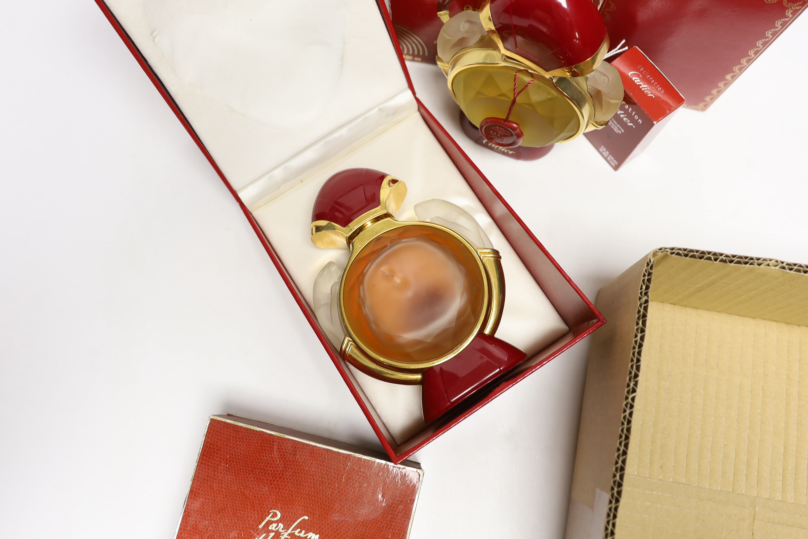 Four bottles of Cartier ‘Panthere’ perfume (three boxed boxed) plus a small bottle of Cartier eat de toilette, and a boxed bottle of Hermes, Paris perfume.